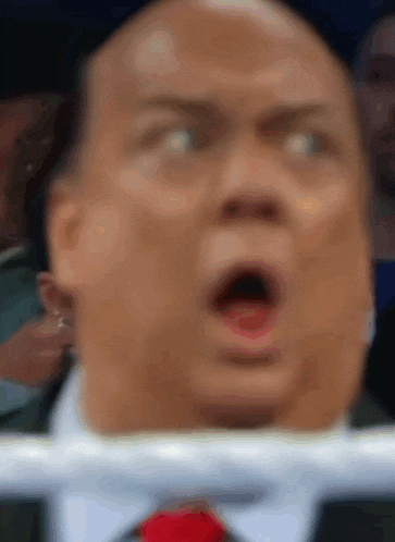 a close up of a man 's face with a surprised look on his face